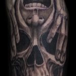 Chris DeLauder Tattoo Artist black and grey skull and face